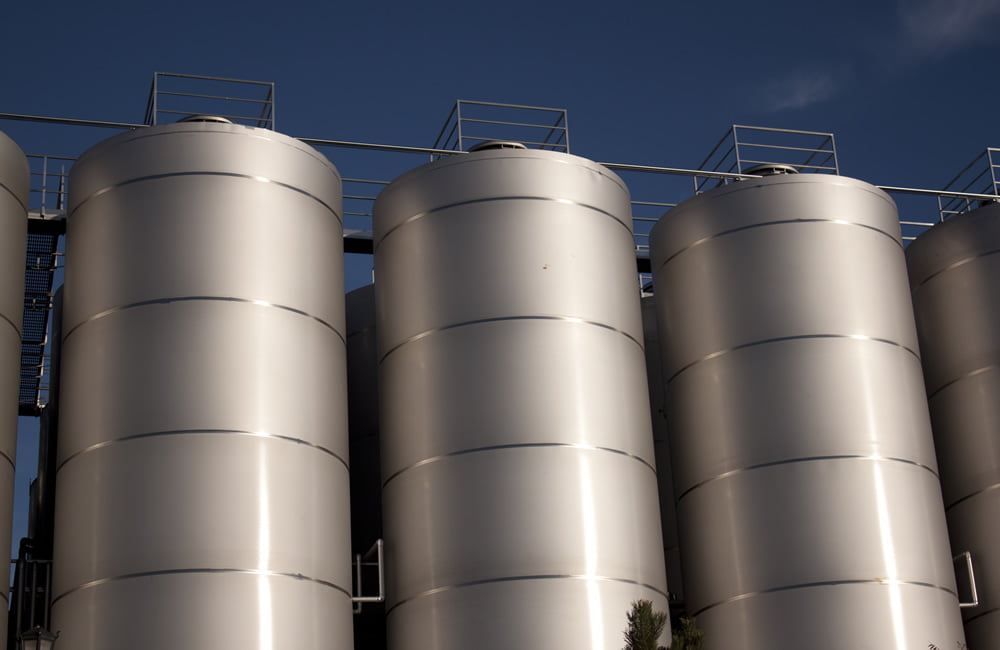 three silver silos of a factory
